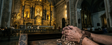 Close-up of calloused, weathered hands holding a wooden rosary on a worn pew in a dimly lit Philippine cathedral, with a blurred opulent gold altar in the background