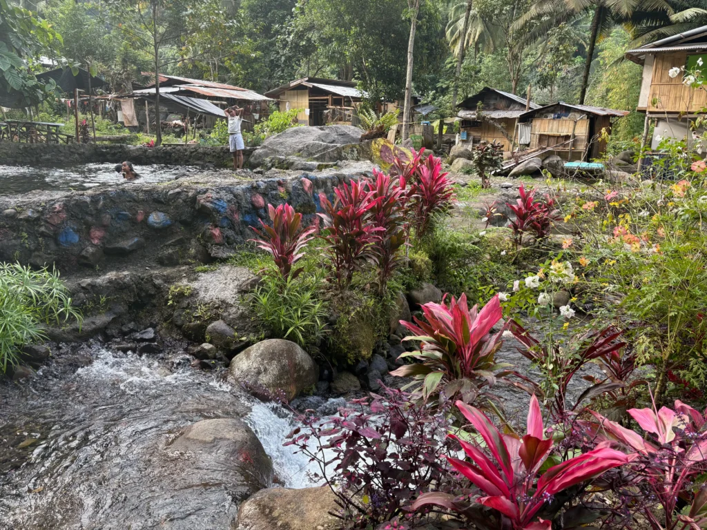Sobsob Therapeutic Spring Resort Davao pools and house of locals