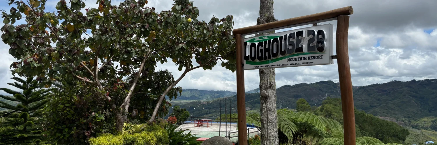 loghouse 28 mountain resort kitaotao bukidnon signage with landscape view
