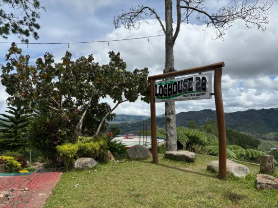 loghouse 28 mountain resort kitaotao bukidnon signage with landscape view