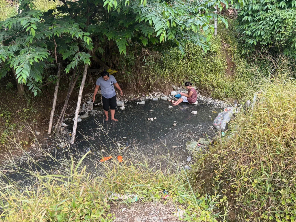 Bukal sa Kanal Natural Hot Springs Purok Mainit Maragusan dark pebbles stones where small hot springs from.